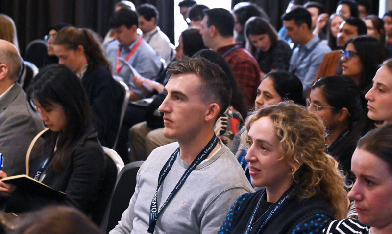 Close up of members of an audience attending a conference
